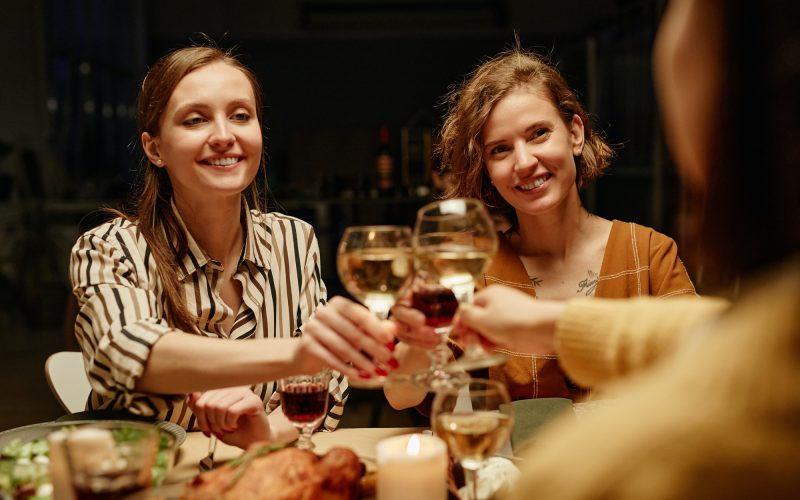 Girls toasting with wine at party
